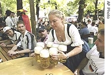 A German waitress serves beer to soccer fans in a German beer garden